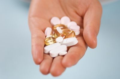 Handful of common vitamins and supplements in pill form