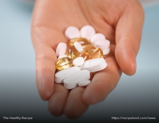 Handful of common vitamins and supplements in pill form