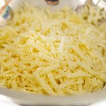 Shred cheese and add into a large bowl.