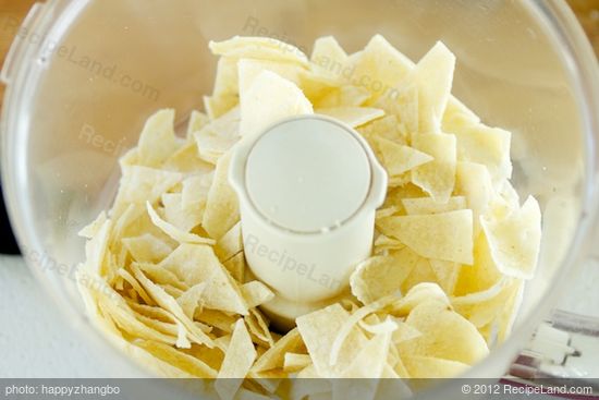 First cut the corn tortillas into ninths, place in a food processor.