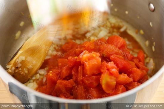 Add tomatoes with juice.