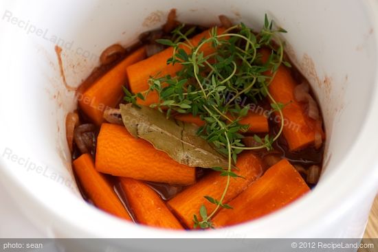 Add the carrots, bay leaf and thyme sprigs to the crock or pot.  