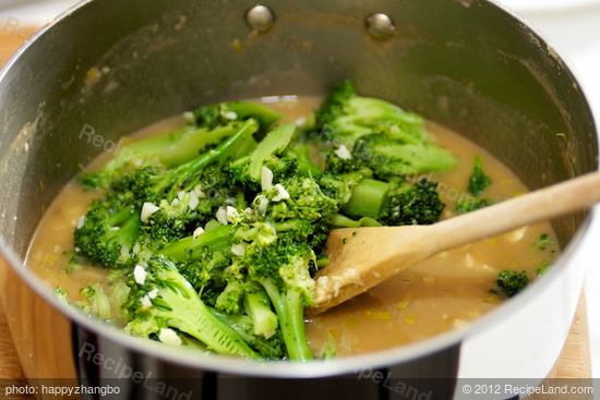 Add broccoli pieces to broth.