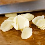 Crush the garlic slightly with the back of your knife.