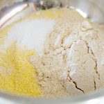 In a mixing bowl stir together flour and cornmeal.  