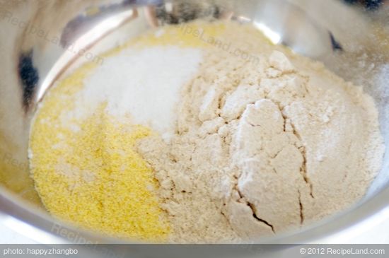In a mixing bowl stir together flour and cornmeal.  
