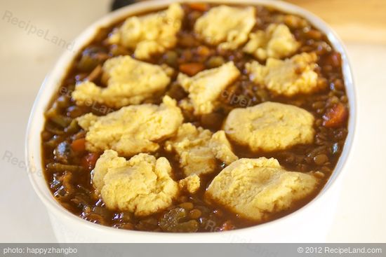 Spoon corn bread mixture on top of the chili.