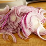 Thinly slice the onions.