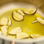 Heat olive oil with garlic in a small saucepan
