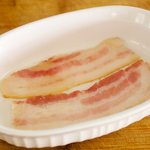 Line the bottom of a casserole with half the bacon slices,