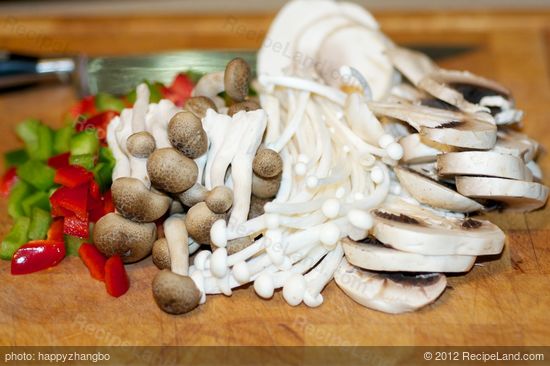 Chop up bell peppers into cubes, and prepare the mushrooms.