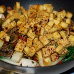 Add the tofu cubes back into the wok or skillet,