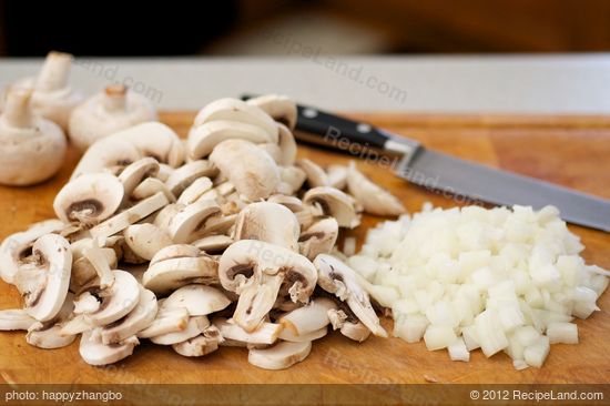 Chop up the onions and slice up the mushrooms.