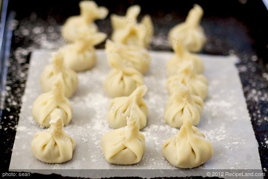 Place the finished dumplings on a tray