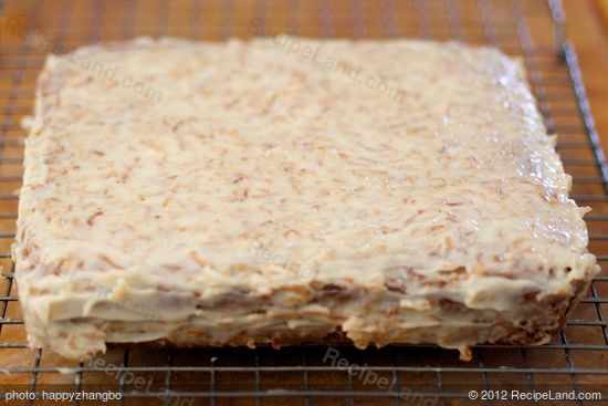 Spread icing evenly over cake,