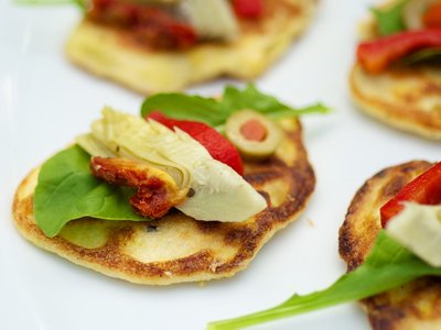 Fresh Corn Blinis with Roasted Bell Pepper, Artichoke Hearts and Arugula