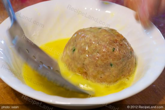 Transfer floured egg into beaten egg.