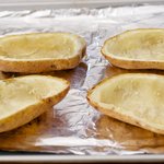Place the now-empty potato shells on the same baking sheet,
