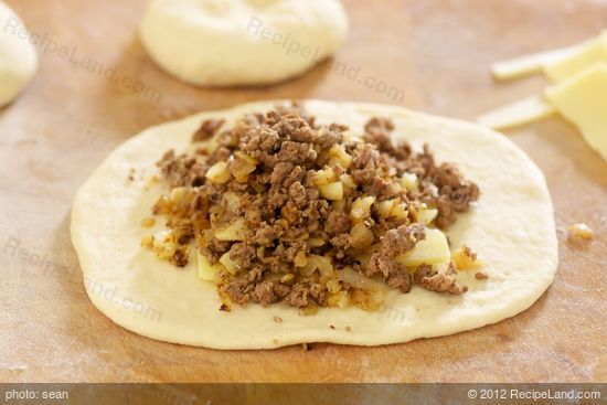spoon about 3/4 cup of the beef and cabbage filling over the cheese