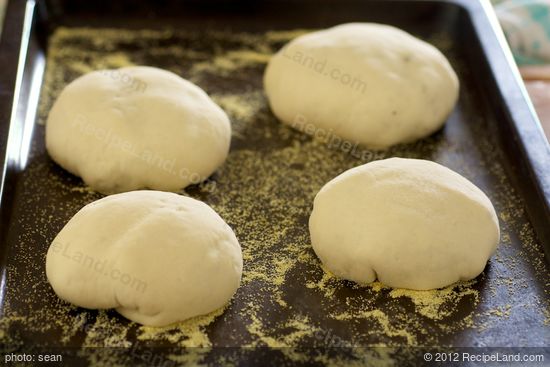 Transfer the bun, seamed side down to the baking sheet.