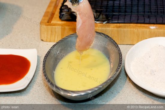 Dip the chicken into the egg mixture.