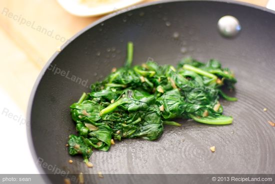 Transfer the spinach into a colander,