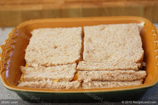 Final layer of bread added to the casserole