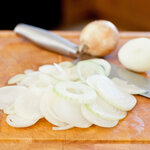 Sliced onions on a cutting board