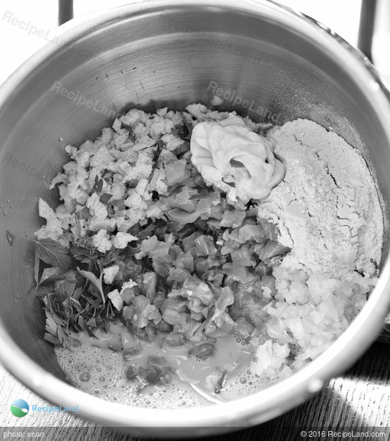 Ingredients for salmon cake in stainless mixing bowl