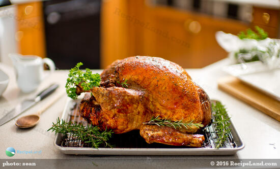 Golden roasted turkey wrapped in parchment paper