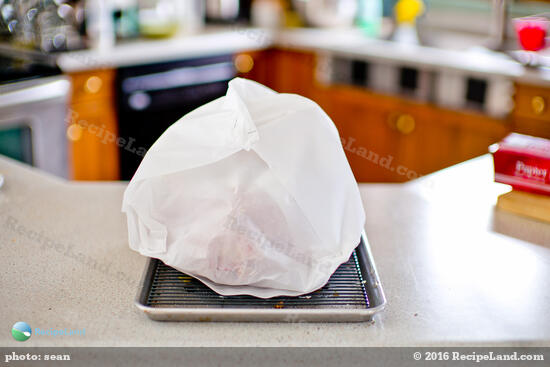 Turkey wrapped in parchment paper, ready for the oven