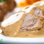 Perfectly cooked juicy pork tenderloin marinated in mustard and thyme served with a white wine cream sauce.  This sauce is perfect for the pork and any sides such as steamed potatoes and carrots.