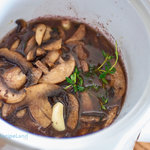 Add the mushrooms to the slow cooker, cover and let simmer.
