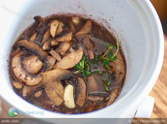 Add the mushrooms to the slow cooker, cover and let simmer.