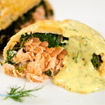 Salmon and spinach stuffed inside of puff pastry then roasted until golden. Crispy and flaky on the outside, served with a tangy and creamy sauce.