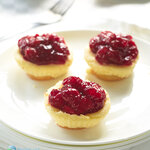 Mini cheesecakes with vanilla wafers, topped with cherry pie filling. Best of all they're so easy to make! Cheesy, smooth and delicious cheesecake that is made in your muffin pan.