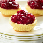 Mini cheesecakes with vanilla wafers, topped with cherry pie filling. Best of all they're so easy to make! Cheesy, smooth and delicious cheesecake that is made in your muffin pan.