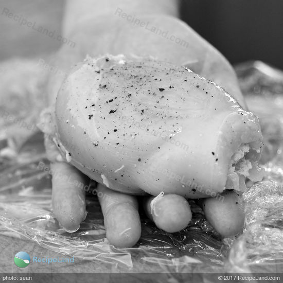 Raw chicken breast stuffed with crab meat and seasoned with salt and black pepper