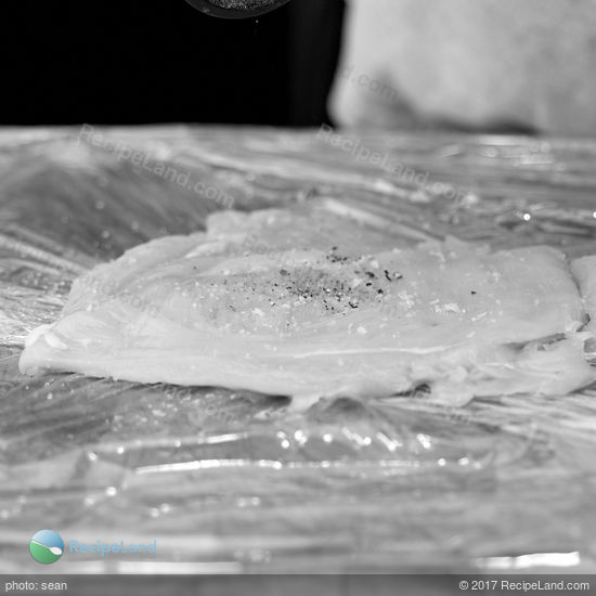 Chicken breast pounded flat, seasoned with salt and pepper ready for stuffing