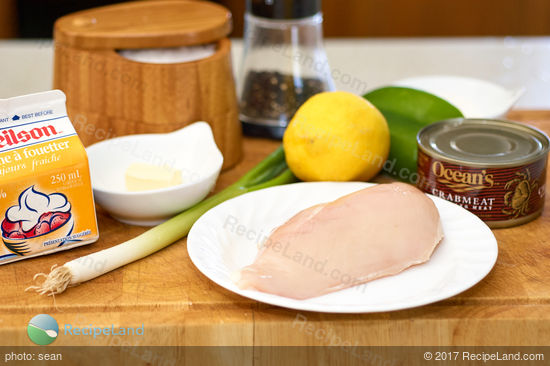 Ingredients for making chicken breasts Neptune assembled on a cutting board