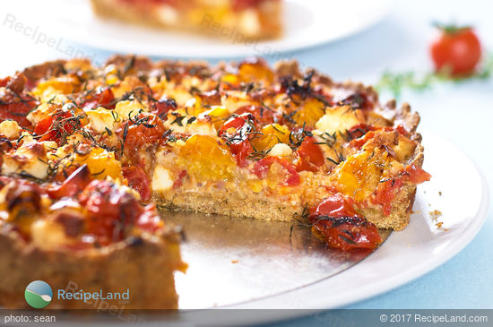 This delicious savory tart is made with roasted cherry tomatoes, feta cheese, and fresh herbs. It's cheesy, sweet, juicy and very tasty. You can have it as an appetizer or a main dish!