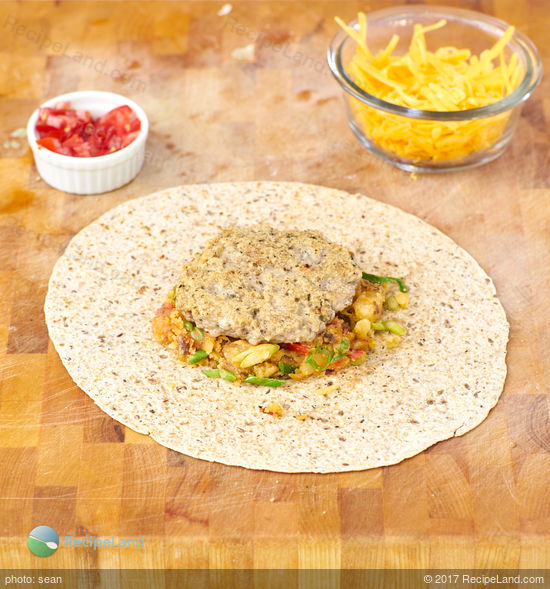 Skip the fast food queue - it's easy to make your own breakfast wraps at home. Crispy home fried potatoes, egg, cheese and a sausage patty wrapped up in a crispy tortilla.