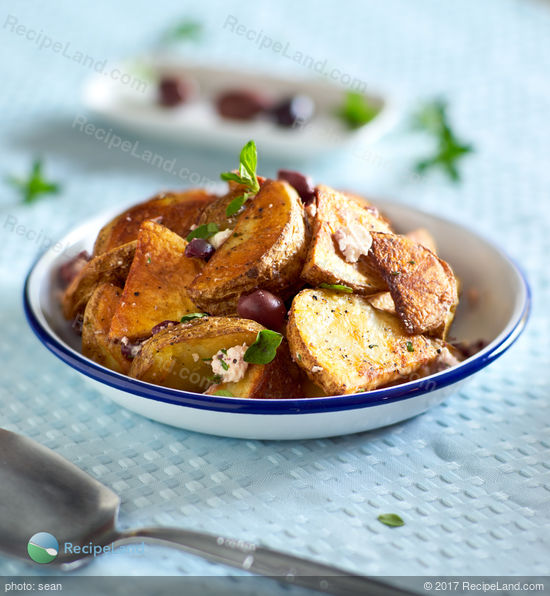 Oven roasted potatoes with garlic, olives, feta and oregano