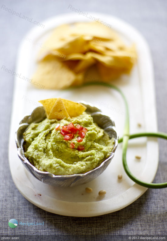 Garlic scapes lift this bean dip into a seasonal, delicious and healthy beginning of summer dip.A fluffy and billowing fresh green colored dip with a velvety texture and mildly assertive green garlic warmth to wrap around any crudites of your choosing.