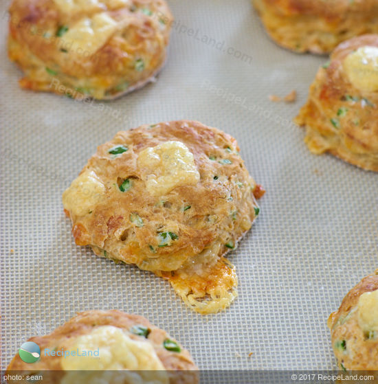Turn garlic scapes into fluffy, cheesy buttermilk biscuits. The garlic scapes add a fresh mild hint of garlic to the savory biscuits which is perfectly complimentary.