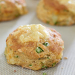 Turn garlic scapes into fluffy, cheesy buttermilk biscuits. The garlic scapes add a fresh mild hint of garlic to the savory biscuits which is perfectly complimentary.