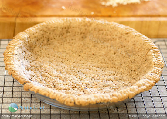 Blind baked herbed pie crust ready for filling in a glass <a href=