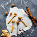 Raw ingredients for Pumpkin Pie Spice mix arranged on a black chalkboard background