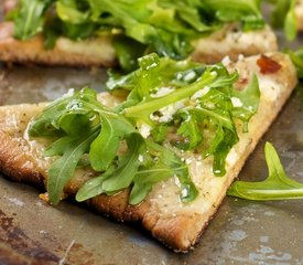 Cheesy and Garlicky White Pizza topped with Fresh Arugula 