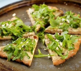 Cheesy and Garlicky White Pizza topped with Fresh Arugula 